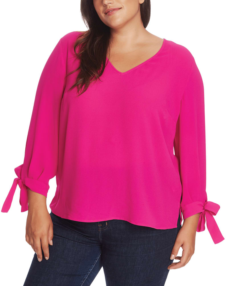 Front of a model wearing a size 1X Bailey Tie-Sleeve Blouse in GARDEN ROSE by CeCe. | dia_product_style_image_id:263344